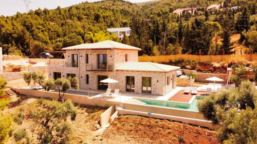 an aerial view of a house with a swimming pool at Limestone House in Athani