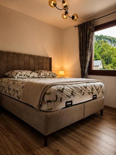 a bedroom with a bed with a large window at Nature escape cottage in Cetinje