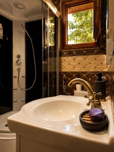 a bathroom with a sink and a shower at Nature escape cottage in Cetinje
