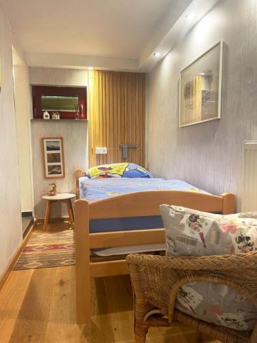 a bedroom with a bed and a chair in it at Ferienwohnung Lahntalblick in Weilburg