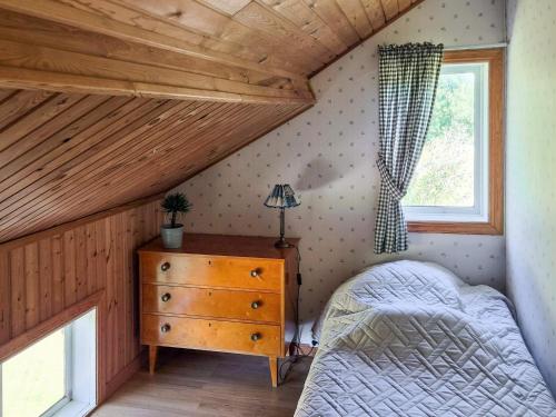 a bedroom with a bed and a dresser and a window at 11 person holiday home in HÖGSÄTER-By Traum in Högsäter