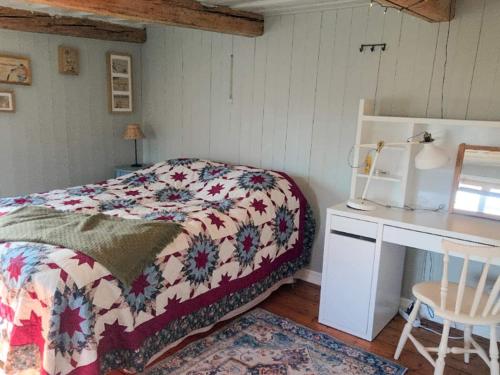 a bedroom with a bed and a desk and a table at 4 star holiday home in Uppsala-By Traum in Uppsala
