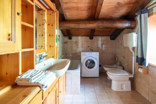 a bathroom with a sink and a washing machine at The WoodHouse in Livigno