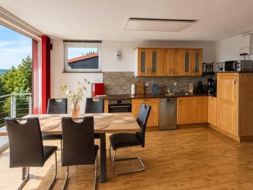 a kitchen and dining room with a table and chairs at Ski- und Wanderurlaub im Wald Ferienhaus Adlerblick in Schnett