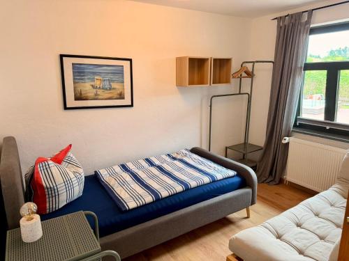 a living room with a blue couch in a room at Wohnung in Dargun mit Garten in Barlin