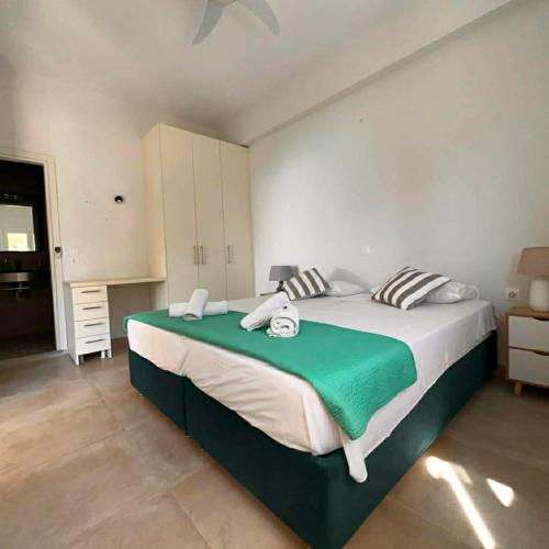 a bedroom with a large bed in a room at Ellia Mirtiotissa Rooms in Glyfada