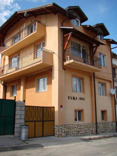 a large building with two balconies on top of it at Yana Guest House in Dobrinishte