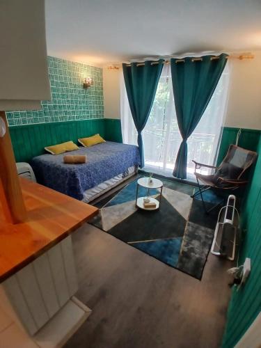 a bedroom with a bed and a chair and a window at Departamento en Pucón in Pucón
