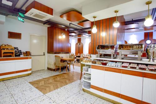 a restaurant with a table and a kitchen with food at The Central Hotel in Istanbul