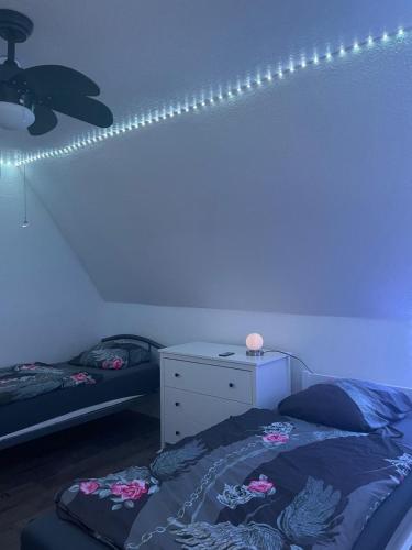 a bedroom with a bed and lights on the wall at Stadtmitte Kitzingen in Kitzingen