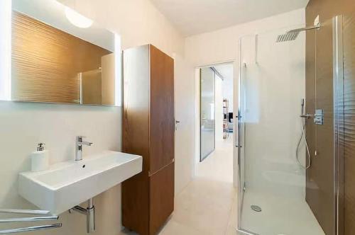 a bathroom with a sink and a shower at Cozy Villa with Pool in Como