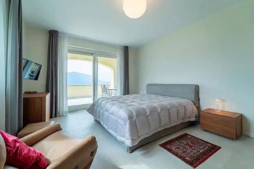 a bedroom with a bed and a large window at Cozy Villa with Pool in Como