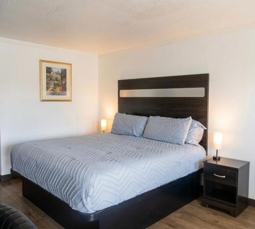 a bedroom with a large bed with two night stands at Big Chief Motel in Battle Mountain