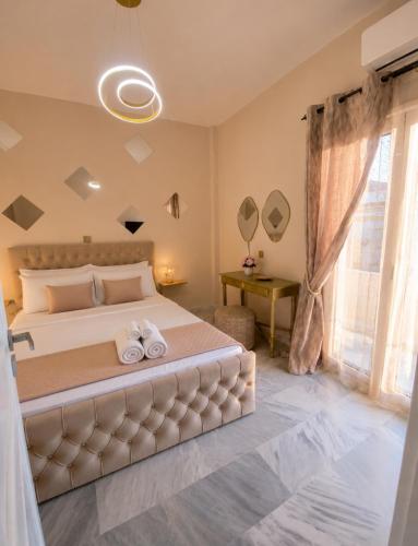 a bedroom with a large bed with towels on it at Aris Studios in Karlovasi