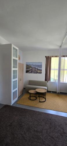 a living room with a couch and a table at Ferienwohnung-Edna-Traunkirchen in Traunkirchen