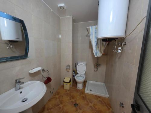 a small bathroom with a sink and a toilet at APP Apartament in Durrës