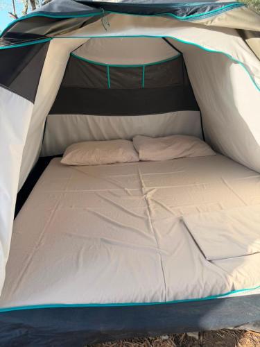 a bed inside of a tent at SeaGrove Camping in Himare