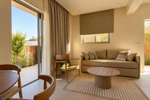 a living room with a couch and a table at MIRA MARE - Apartments 1 & 8 in Stavros