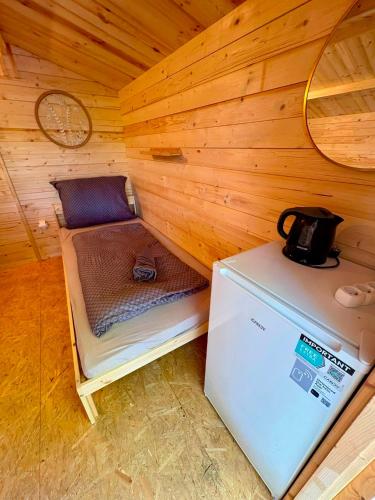 a small room with a refrigerator in a cabin at Glamping 68 - Summer cottage in Kámen