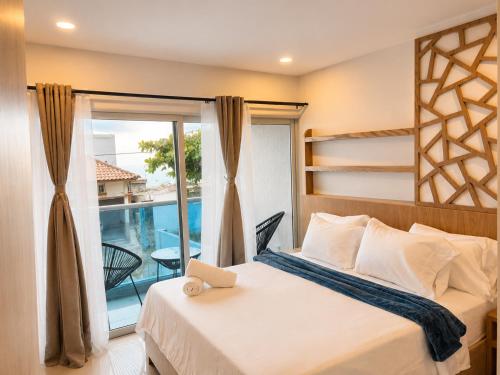 a bedroom with a bed and a window with a view at Hotel Azure Cartagena in Cartagena de Indias