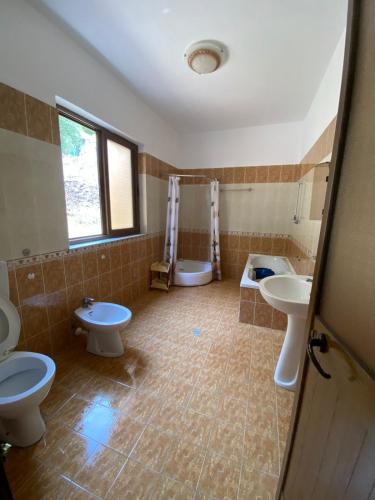 a bathroom with two sinks and two toilets at Ankor view in Shëngjin