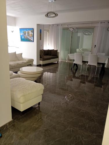 a living room with a couch and a table at Iris in Valras-Plage