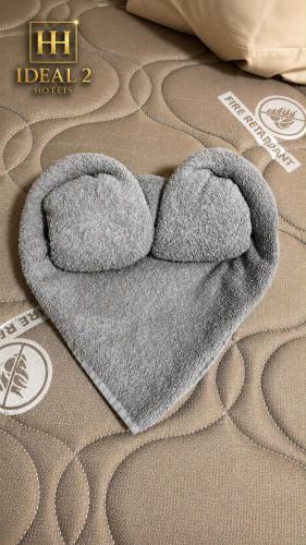 a heart shaped blanket laying on a bed at Hotel ideal 2 in Inocência