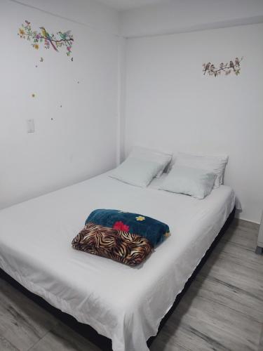 a white bed with a pillow on top of it at Donde poyito in Sevilla