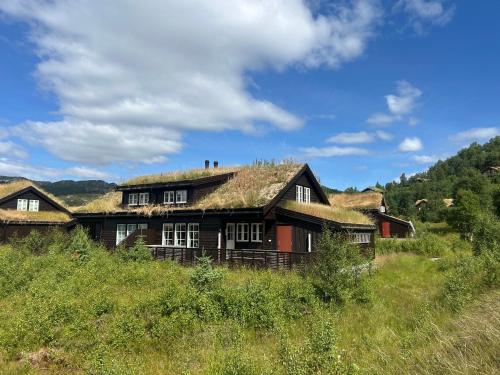 an old house with a grass roof on a hill at Sirdal in Dirdal