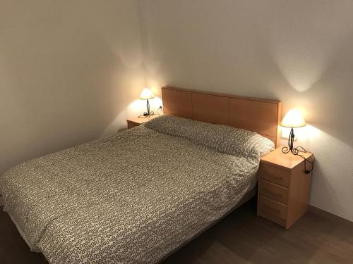 ein Schlafzimmer mit einem Bett und zwei Lampen an Tischen in der Unterkunft La mestrança in Blanes