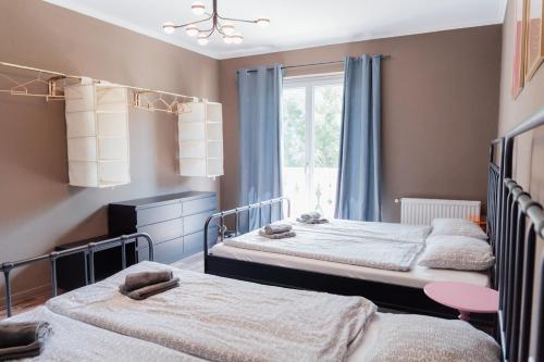 a bedroom with two beds and a window at MiHome - Grimming View Apartment in Tauplitz
