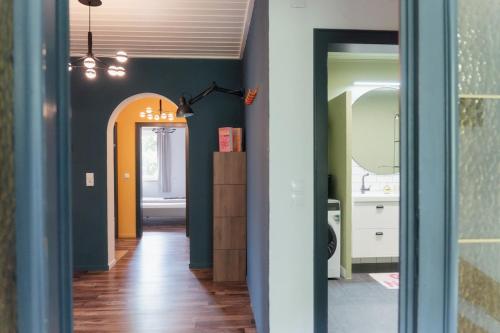 a hallway leading to a bathroom with a hallway at MiHome - Grimming View Apartment in Tauplitz