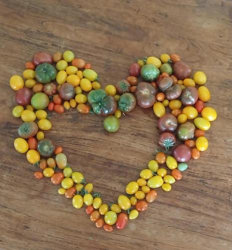 a heart made out of beads on a wooden table at Pureanei in Rawene