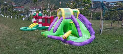 a set of three inflatable playground equipment in the grass at Camper Park Lake View in Mëmëlisht