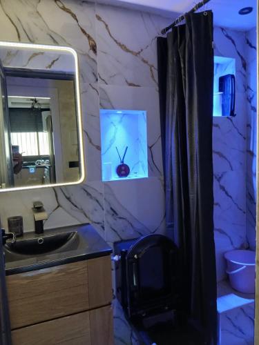 a bathroom with a sink and a mirror at Ikamat raha in Tangier