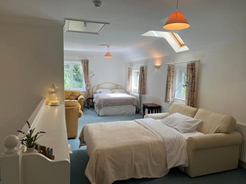 a living room with a bed and a couch at Hidden cottage in Abingdon