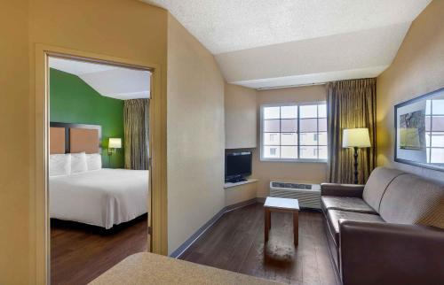 a hotel room with a couch and a bed at Extended Stay America Suites - Los Angeles - Torrance - Del Amo Circle in Torrance