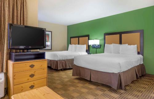 a hotel room with two beds and a flat screen tv at Extended Stay America Suites - Seattle - Bothell - Canyon Park in Bothell