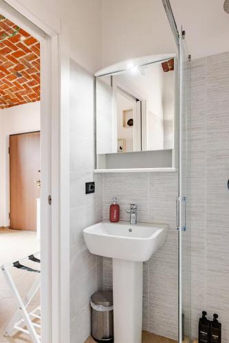 a white bathroom with a sink and a mirror at Il Rustico Romantic Suite e Sauna in Ciriè