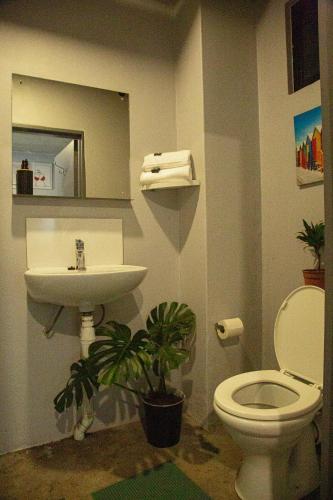a bathroom with a toilet and a sink at The Hideaway Studio-Maboneng in Johannesburg