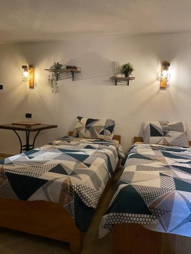 a group of three beds in a room at Korja Apartments Mavrovo in Mavrovo