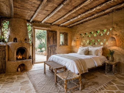 a bedroom with a large bed and a fireplace at Riad chama in Taroudant