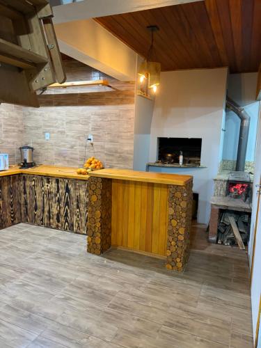 a kitchen with a wooden counter in a room at Espaço Luna in Gramado