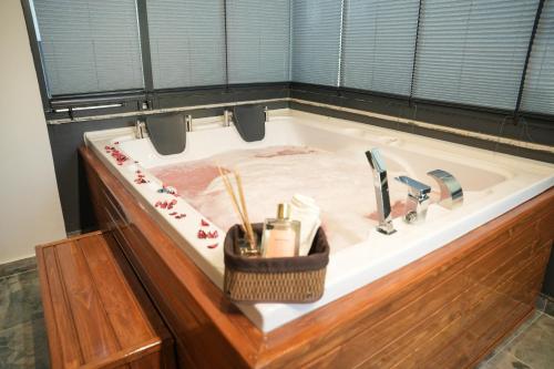 a bath tub with a sink with utensils in it at LİMONOTTO SUİT OTEL in Mersin