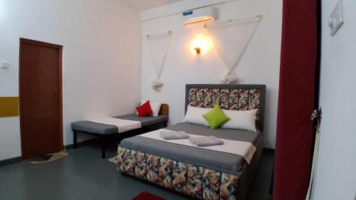 a room with a bed and a chair in it at Family Nest in Dambulla