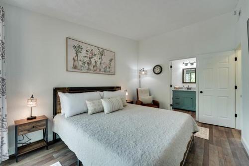 a bedroom with a large white bed and a table at Ozark Mountain Refuge in Kimberling City