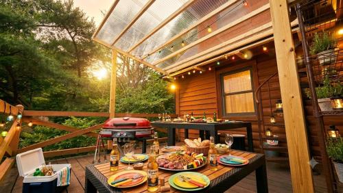 a patio with a table with food and a grill at ログハウス SakuraFamiliar in Kawazu