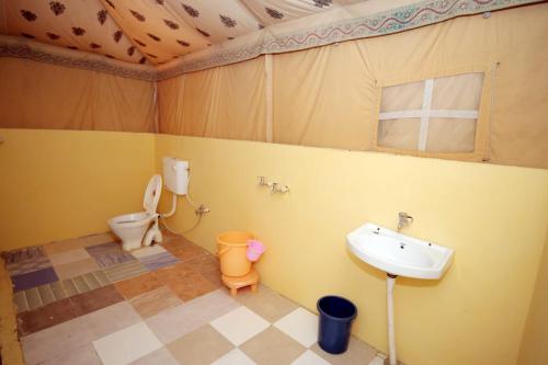 a small bathroom with a sink and a toilet at Mehta Desert camp Sam sand Dunes Jaisalmer in Jāmb