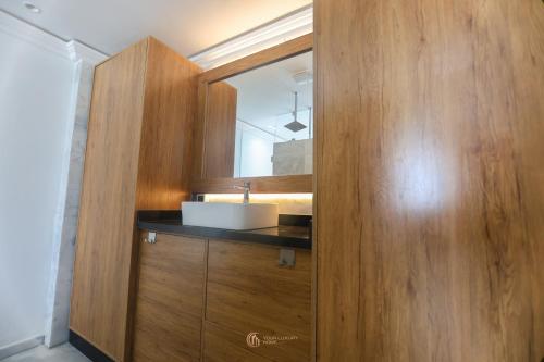 a bathroom with a sink and a mirror at Playablanca Luxury Beach Apartment First Floor in Tanger in Tangier