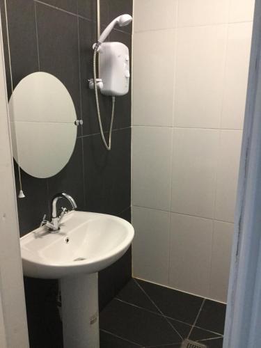 a bathroom with a sink and a mirror at Llandudno holiday home in Llandudno